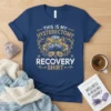 Hysterectomy recovery shirt with "THIS IS MY HYSTERECTOMY RECOVERY SHIRT" text, messy bun, sunglasses, and floral graphics