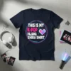 Navy t-shirt with "THIS IS MY K-POP PAJAMA SHIRA SHIRT" text and a neon heart graphic, surrounded by musical notes