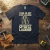 Navy t-shirt with bold yellow text "THIS IS MY STEP LADDER I NEVER KNEW MY REAL LADDER" and a graphic