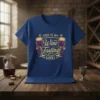 Blue t-shirt with gold text "THIS IS MY Wine Tasting SHIRT" and graphics of wine glasses and grapes
