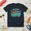 T-shirt with "THIS IS WHAT AN Awesome LIFEGUARD LOOKS LIKE" text in blue and yellow, featuring wave graphics