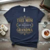 Navy blue t-shirt with gold text that reads "THIS MOM GOT PROMOTED TO GRANDMA" in a vintage style font