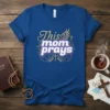 This Mom Prays Christian T-Shirt featuring gold glitter text and halo graphic