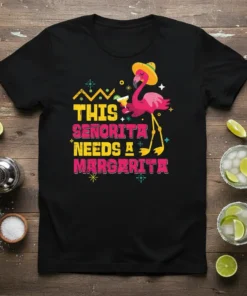 Black t-shirt with "THIS SEÑORITA NEEDS A MARGARITA" text and a cartoon flamingo holding a drink