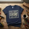 Navy blue t-shirt with distressed text reading "THIS SHIRT SHIRT WAS A GIFT" in a white box graphic