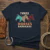 Three horses with bandana and leopard print patterns, text reads "THREE HORSES BANDANAS" on a navy t-shirt