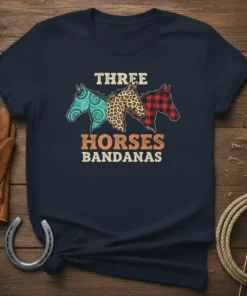 Three horses with bandana and leopard print patterns, text reads "THREE HORSES BANDANAS" on a navy t-shirt