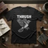 Black t-shirt featuring the word "Thrush" in white block letters above a detailed illustration of a thrush bird in flight
