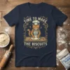 Cat wearing chef hat and apron kneading dough with text "Time to Make the Biscuits" on navy t-shirt