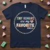 Navy blue t-shirt with colorful text "TINY HUMANS are my FAVORITE #IBCLC" surrounded by a circle of baby footprints