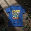 Toon Army text design with a blue fist breaking through a brick wall, on a royal blue t-shirt