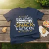 Navy blue t-shirt with "Torn Between Looking Like a Snack & Eating One" text design in white and gold glitter