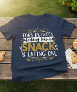 Navy blue t-shirt with "Torn Between Looking Like a Snack & Eating One" text design in white and gold glitter