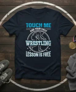 Touch Me And Your First Wrestling Lesson Is Free text on a navy t-shirt with a wrestler graphic in the