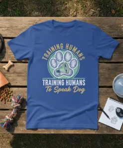 Blue t-shirt with "TRAINING HUMANS To Speak Dog" text, featuring a paw print and megaphone graphic