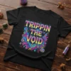 Black t-shirt with "Trippin The Void" text in colorful, dripping psychedelic lettering and abstract graphic elements