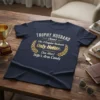 Trophy Husband Like A Regular Husband Only Hotter Wife's Arm Candy funny t-shirt design with gold laurel wreath graphic