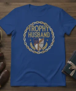 Trophy Husband t-shirt design featuring bold text within a decorative circular emblem with a shield and laurel leaves