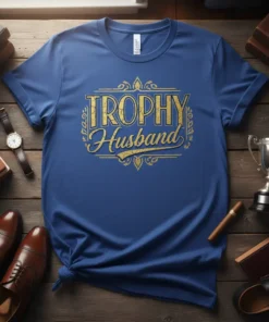 Blue t-shirt with gold "Trophy Husband" text in a decorative frame, symbolizing a husband's award