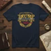 Trump Revenge Tour 2024 text design with golden laurel wreath and red stars on a navy blue t-shirt