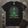 Alien meditating in lotus pose with "Trust the Universe" text and a mandala on a black t-shirt