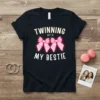 Black t-shirt with "Twinning With My Bestie" text and pink bows graphic