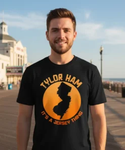 Tylor Ham It's A Jersey Thing T-Shirt featuring a black silhouette of New Jersey within an orange circle, with text