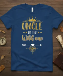 UNCLE OF THE Wild one text with a gold crown and compass graphic on a navy blue t-shirt