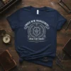 Navy t-shirt with "Under New Management Speak to My Fiancée" text and a shield graphic, indicating an engaged couple's status