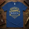 Underestimate Me. Underestimate Me: That'll Be Fun. quote on a navy blue t-shirt with gold ornate graphic elements