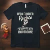 Black t-shirt with white text: "UPON FURTHER Review I'M GOING TO NEED ANOTHER DRINK" and a graphic of a finger
