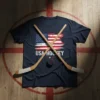 Navy blue t-shirt with distressed American flag and "USA HOCKEY" text, featuring crossed hockey sticks and a puck