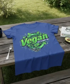 Vegan Just To Annoy You T-Shirt featuring green text and a circular graphic with leaves and a robotic hand holding