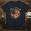 VINTAGE 1961 text above a distressed circular American flag design on a navy blue t-shirt