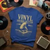 T-shirt with "VINYL SOUNDS BETTER" text and a vintage gramophone graphic, featuring golden yellow design on a blue shirt