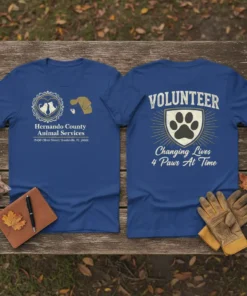 Volunteer t-shirt with "Changing Lives 4 Paws At Time" text and a paw print emblem
