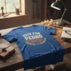 Blue t-shirt with "VOTE FOR PEDRO 2028" in distressed white and red text, surrounded by a gold laurel wreath