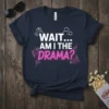 Navy blue t-shirt with white and pink text that reads "WAIT... AM I THE DRAMA?" with question marks and swirling