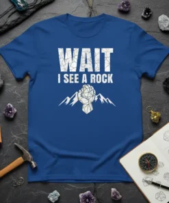 Wait I See A Rock T-Shirt featuring bold white text and a geometric rock graphic with mountains