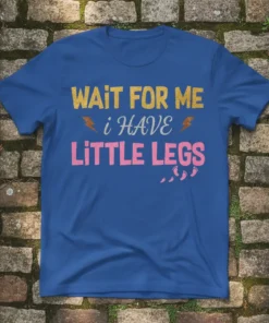 Wait For Me I Have Little Legs T-Shirt featuring gold and pink glitter text with baby footprints graphic