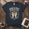 Navy t-shirt with "WAKE & PRAY TRANSFER DAY!" text, hands holding baby feet, and floral wreath
