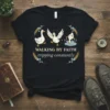 Black t-shirt with "Walking By Faith Tripping Constantly" quote and three cartoon ducks, one falling