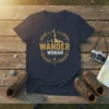 Navy t-shirt with "Wander Woman" text in a circular vintage design featuring mountains, a hiker, and a crescent moon