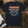 WARNING DOES NOT PLAY WELL WITH LIBERALS text design on a navy blue t-shirt with gear graphic