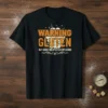 Warning Gluten May Cause Unexpected Explosions text design on a black t-shirt with orange and white distressed lettering and graphic
