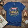 Warning I Am The Crazy Godmother text with dragon and crown graphic on blue t-shirt