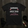 T-shirt with "Warning You Have Entered The Ninja Zone" text, featuring a silhouette of a ninja jumping over a cityscape