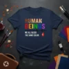 Navy t-shirt with "HUMAN BEINGS WE ALL BLEED THE SAME COLOR" text, featuring rainbow colors and a heart monitor graphic