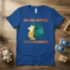 Blue t-shirt with orange text "WE ARE HOPING IT'S A HEDGEHOG" and a geometric hedgehog graphic