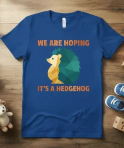 Blue t-shirt with orange text "WE ARE HOPING IT'S A HEDGEHOG" and a geometric hedgehog graphic